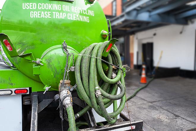 a service truck pumping grease from a restaurant's grease trap in Akron